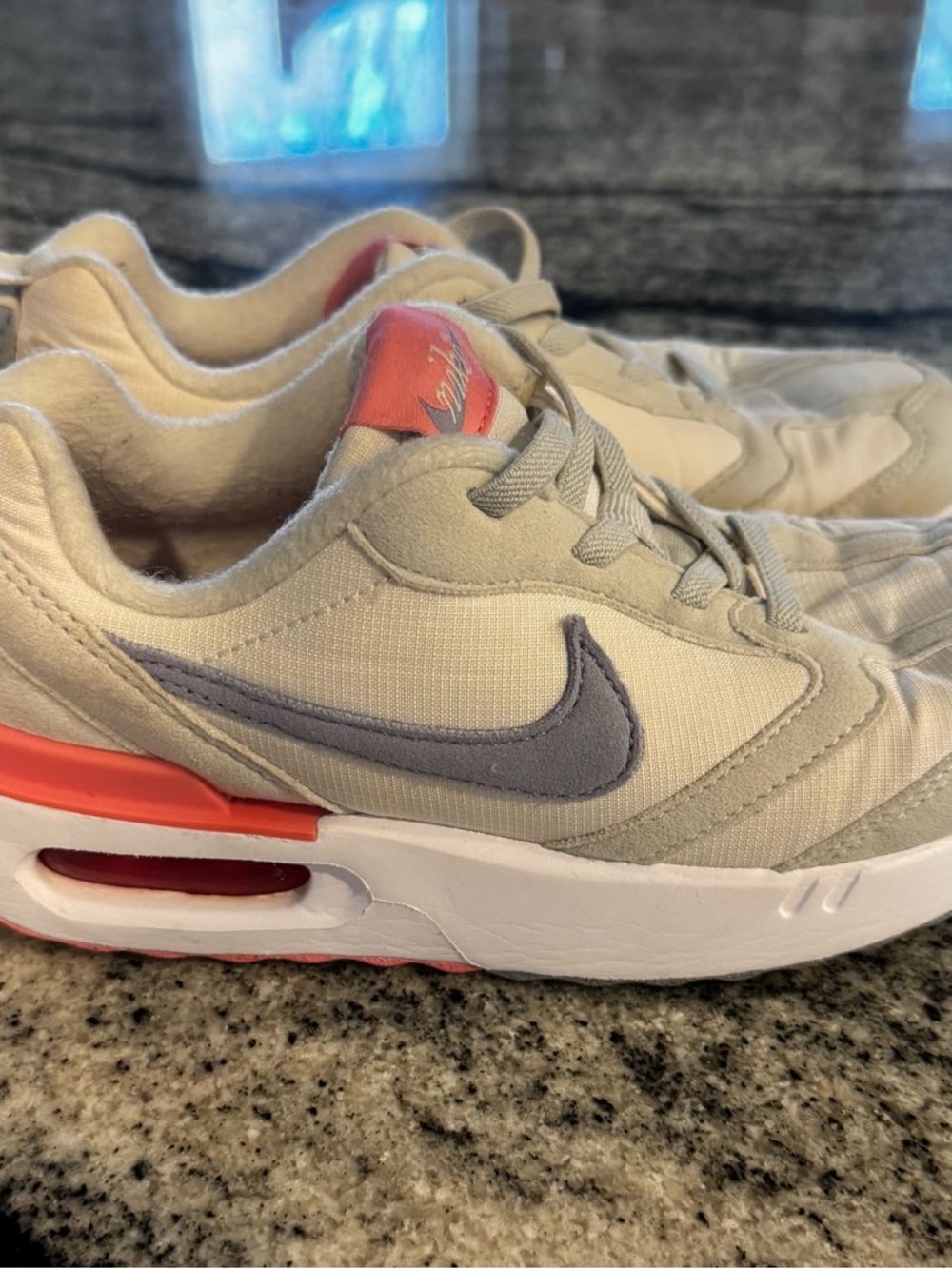 Nike cream sneakers with gray Swoosh and coral accents
